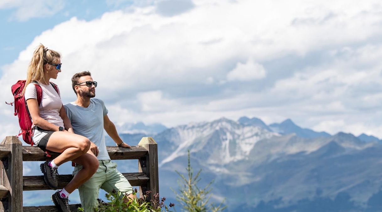 Two people are enjoying the mountain panorama