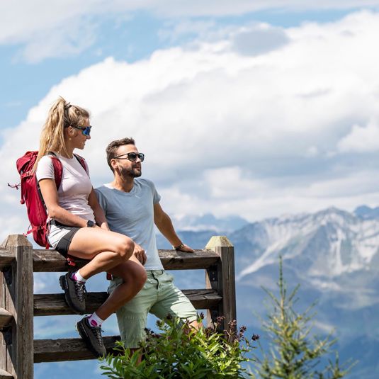 Two people are enjoying the mountain panorama