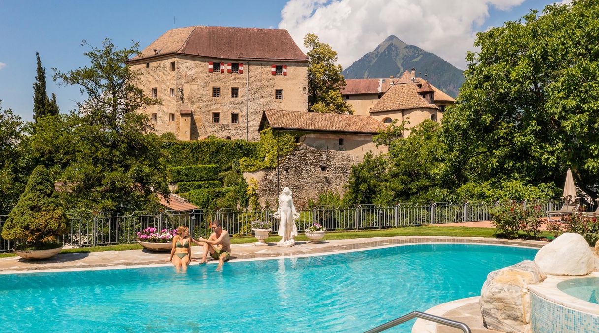 Two guests at the outdoor pool of our wellness hotel near Merano/Meran