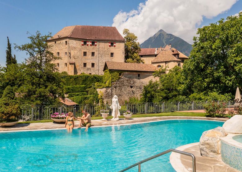 Two guests at the outdoor pool of our wellness hotel near Merano/Meran